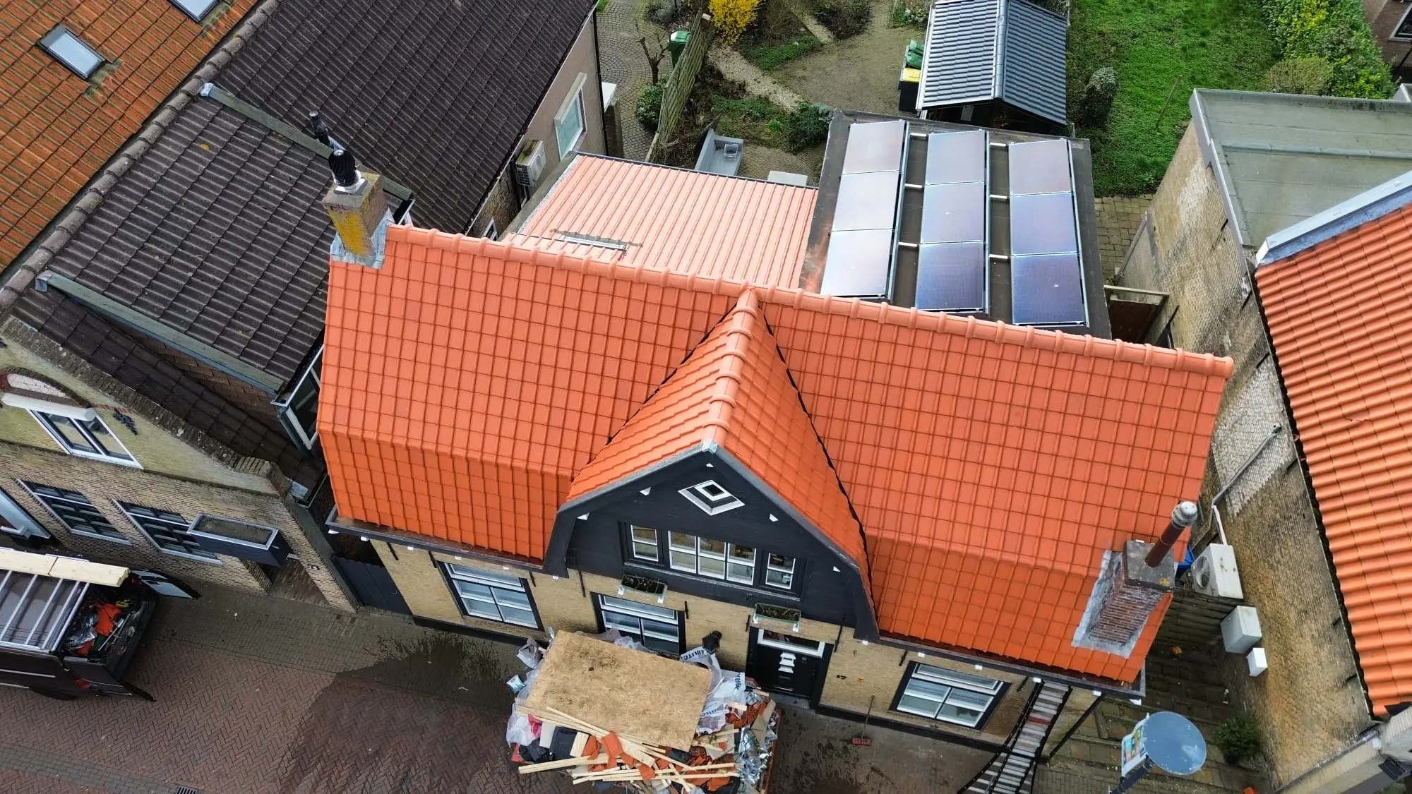 Gerenoveerd mansardedak met oranje dakpannen, vanuit de lucht
